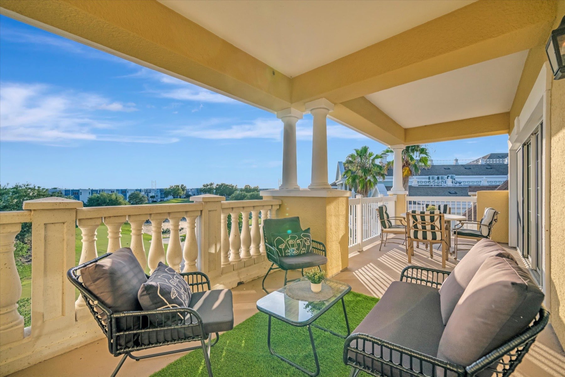 Covered balcony with outdoor seating at a Florida vacation rental